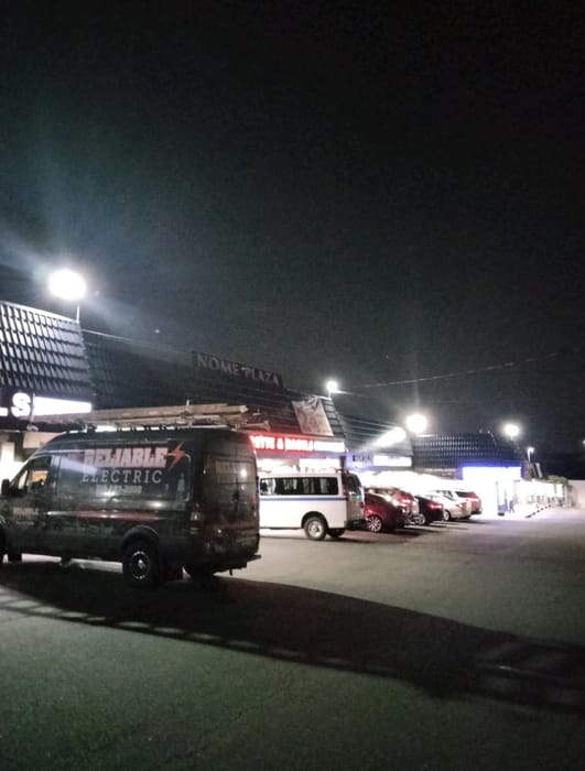 Reliable Electric service vans on a commercial job at night
