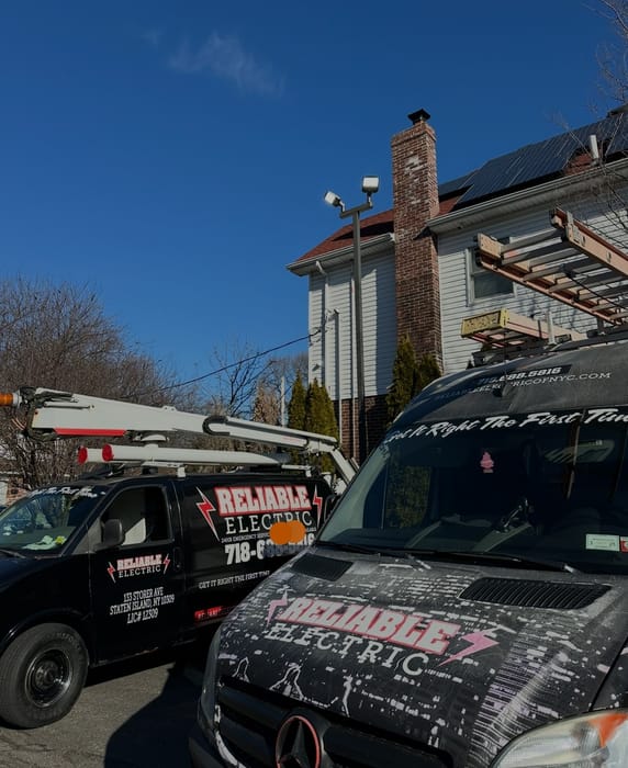 Bucket truck and service van at a residential job